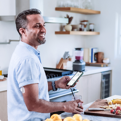 man cooking in kitchen wearing dexcom