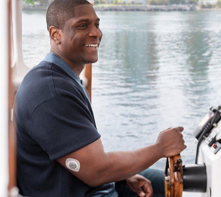 Man driving boat wearing stelo