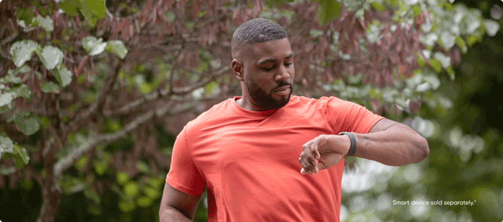 man outdoors checking smart watch