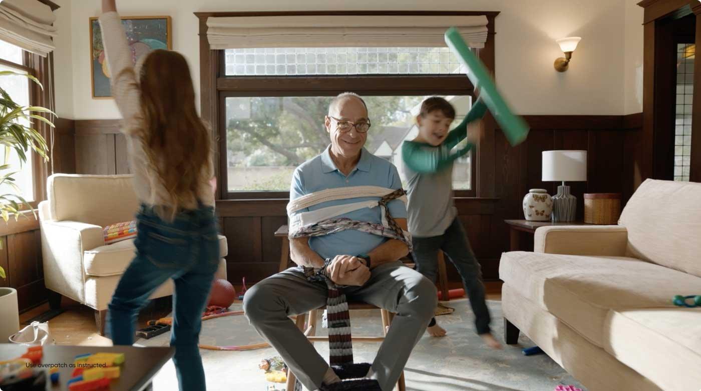 man playing with children in living room
