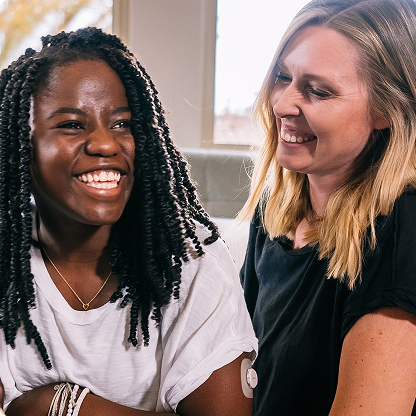 mom and daughter smiling together