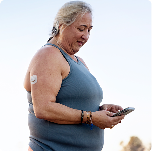 woman smiling looking at her phone