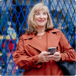 woman in red jacket holding phone