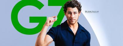 nick jonas holding a dexcom sensor in his hands