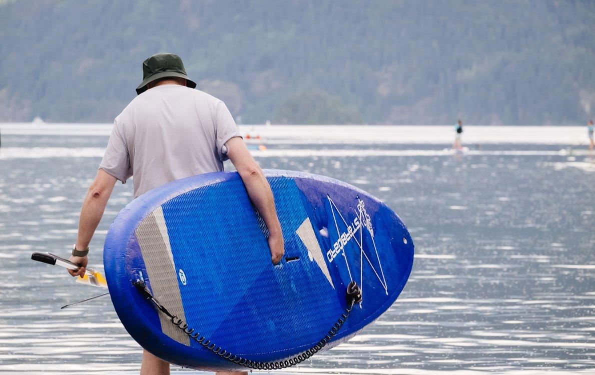 Couple smiling under umbrella outdoors man wearing Dexcom G7 back of arm