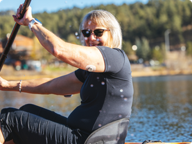 Woman kayaking wearing Dexcom G7 and Omnipod 5