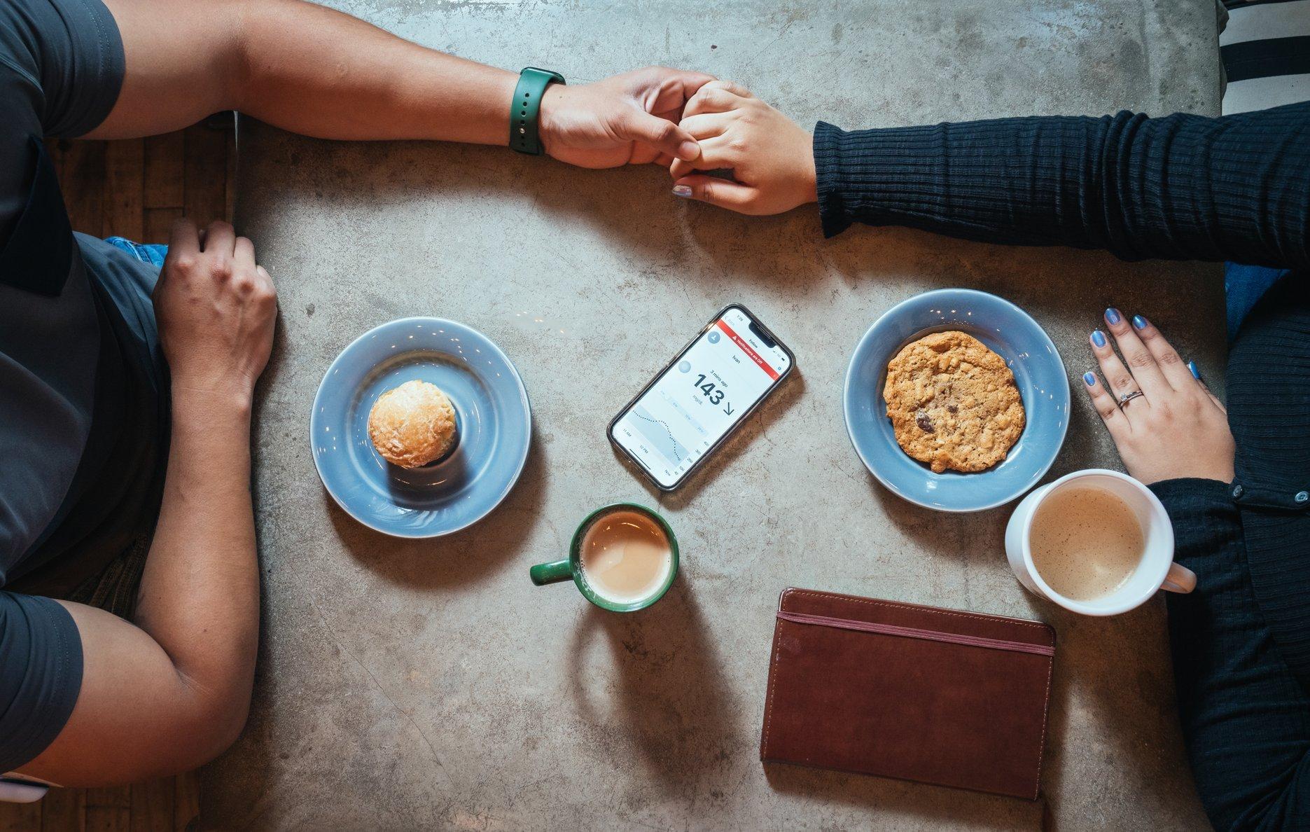 Woman wearing dexcom sensor holding tape