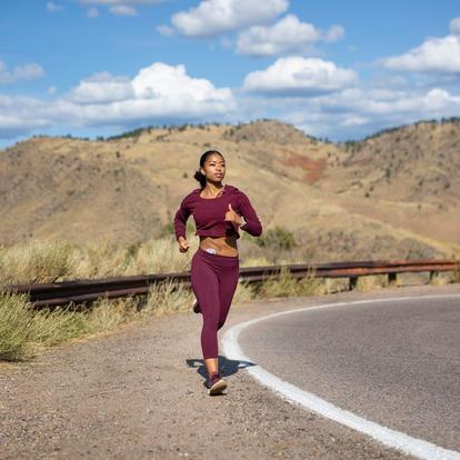 woman running outdoors with dexcom on abdomen