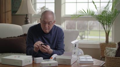 Man opening Dexcom boxes and getting started and setting up his Dexcom G6 Receiver