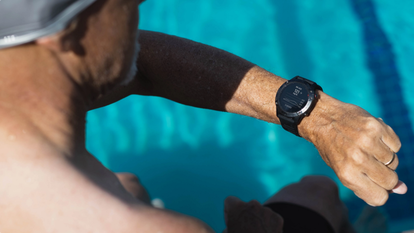 Man checking his smart watch in the pool
