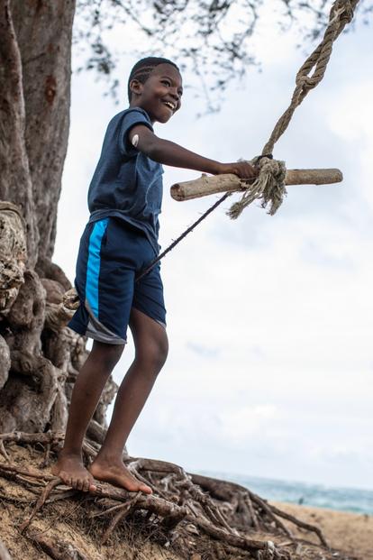 boy on rope swing wearing dexcom g7 sensor