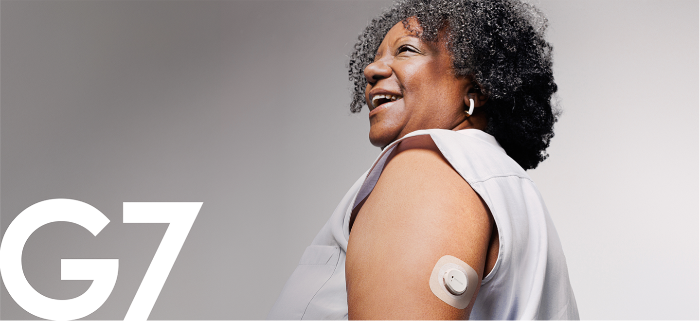 woman smiling wearing dexcom