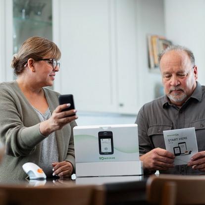 man and woman opening dexcom packaging