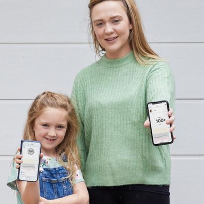 Mother and Daughter Showing Dexcom Follow App on their phones