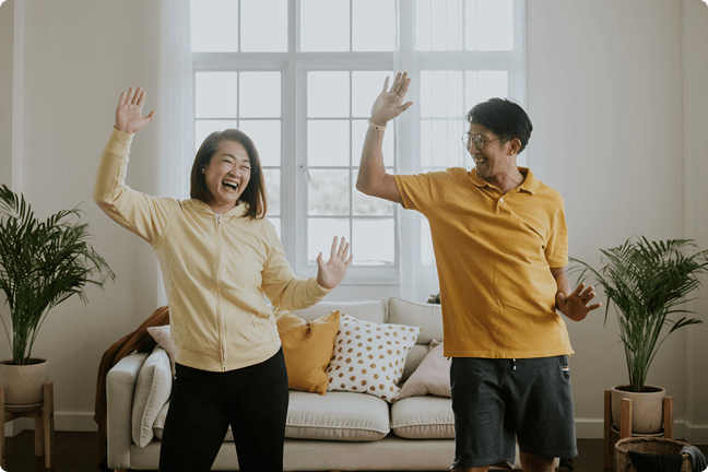 Woman and man dancing in their living room