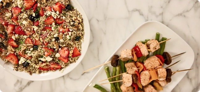 Granola and chicken skewers on a table