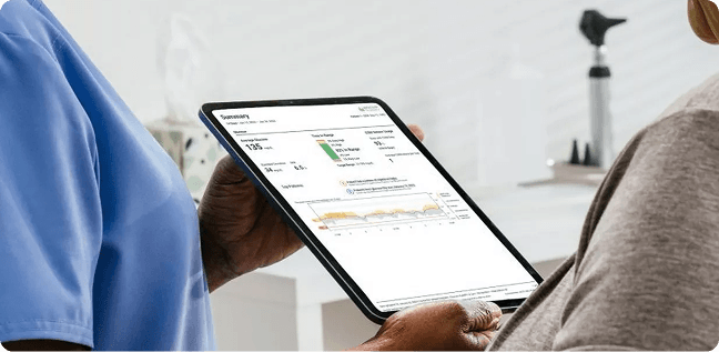Doctor going over lab report with patient on a tablet