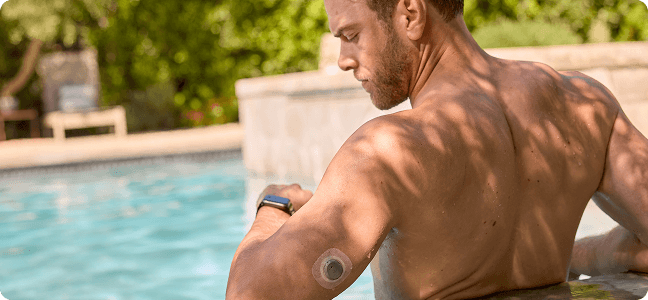 Man looking at his watch standing in a pool