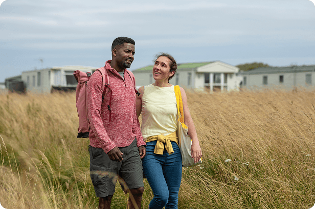 Two people walking in a field