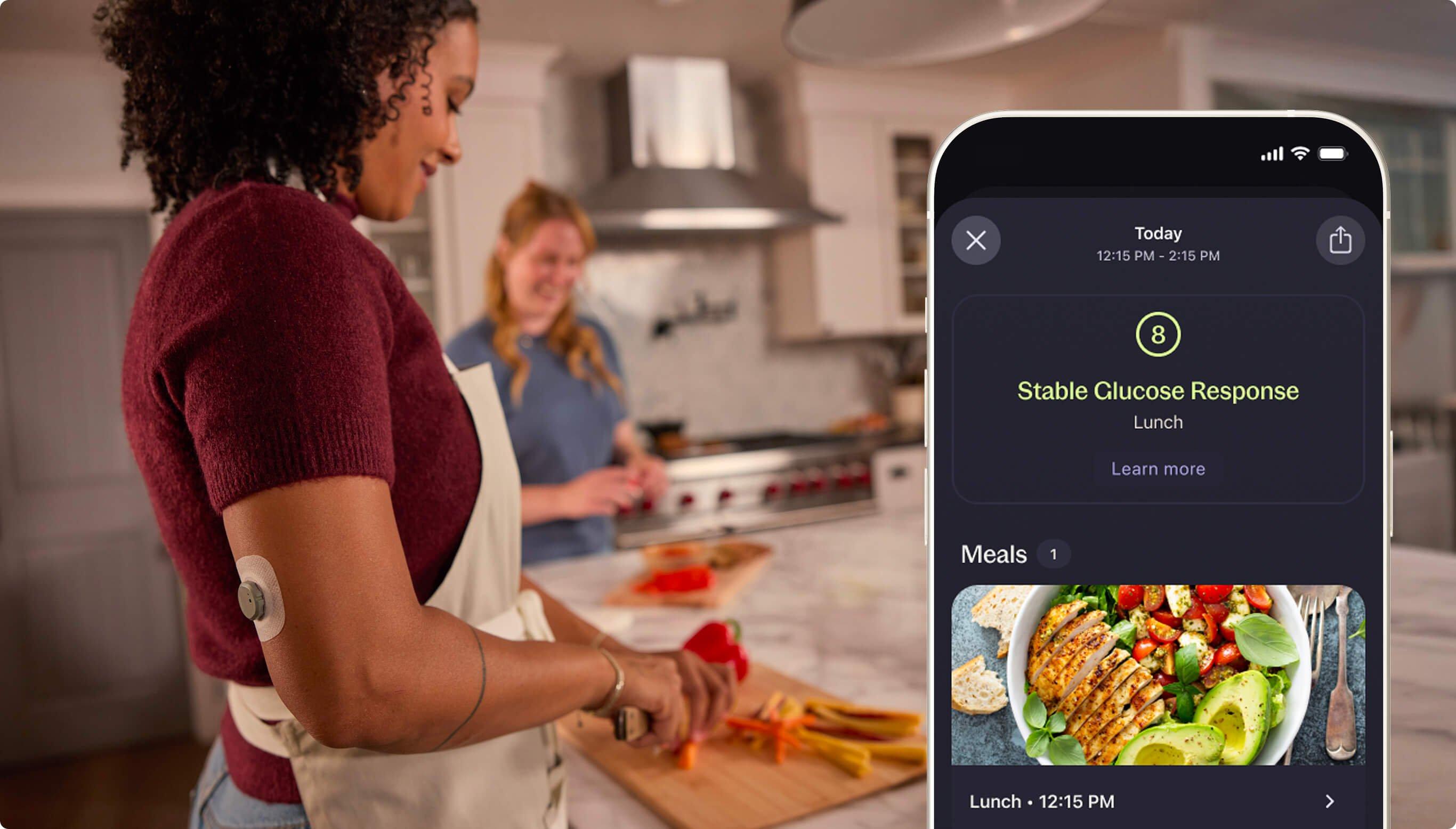 Woman cutting vegetables and phone screen showing Glucose Response to logged Lunch