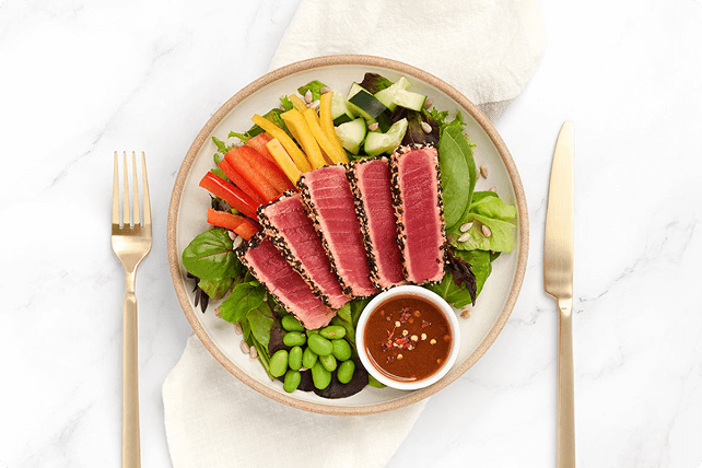 Seared tuna salad with vegetables and dipping sauce.