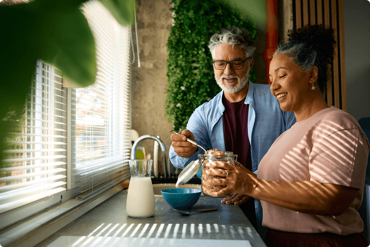 Woman and man preparing breakfast