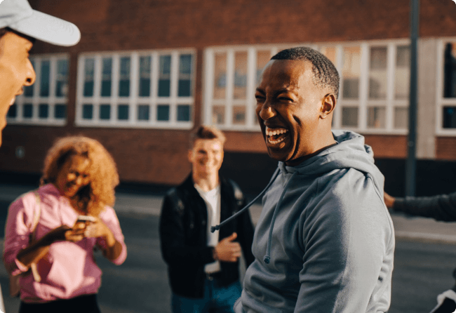 Man laughing with friends outside