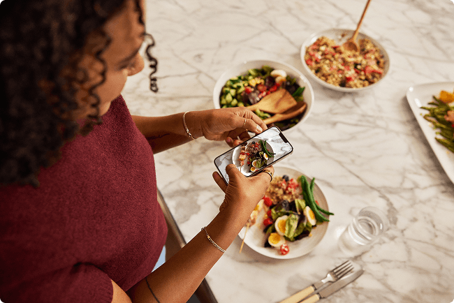 Woman taking a picture of her meal plate