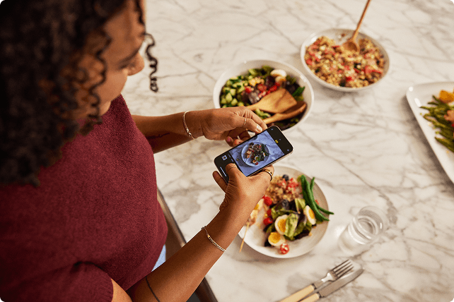 Woman taking a picture of her plate of food