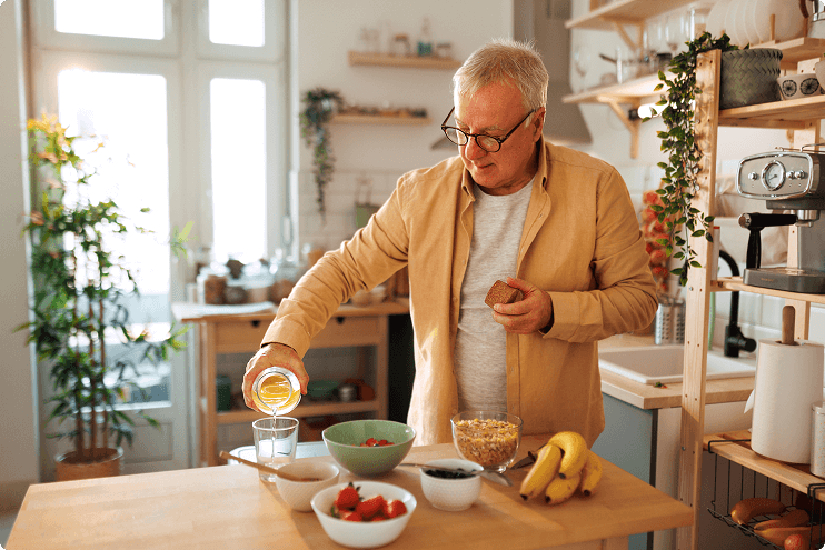 Man pouring himself a drink at breakfast
