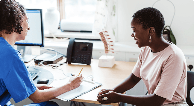 Woman with her doctor who is taking notes