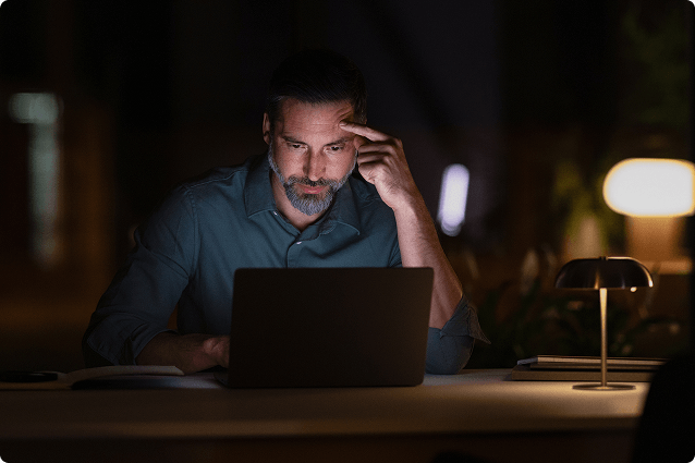 Man working on his computer at night