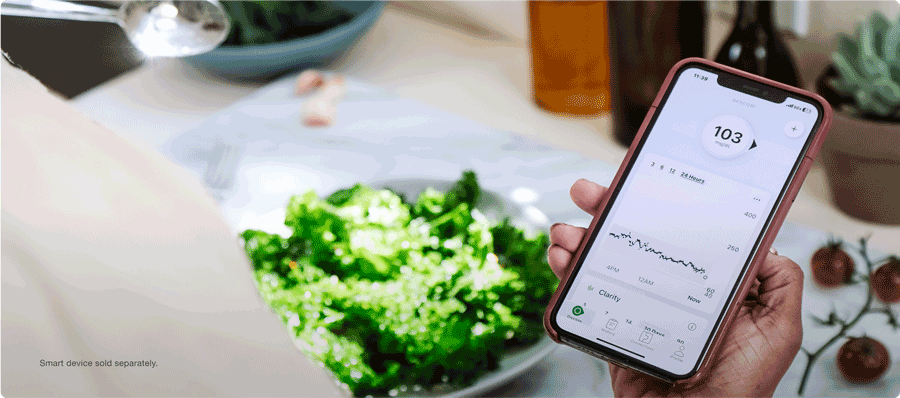 Checking glucose levels on the Dexcom CGM app while eating a salad