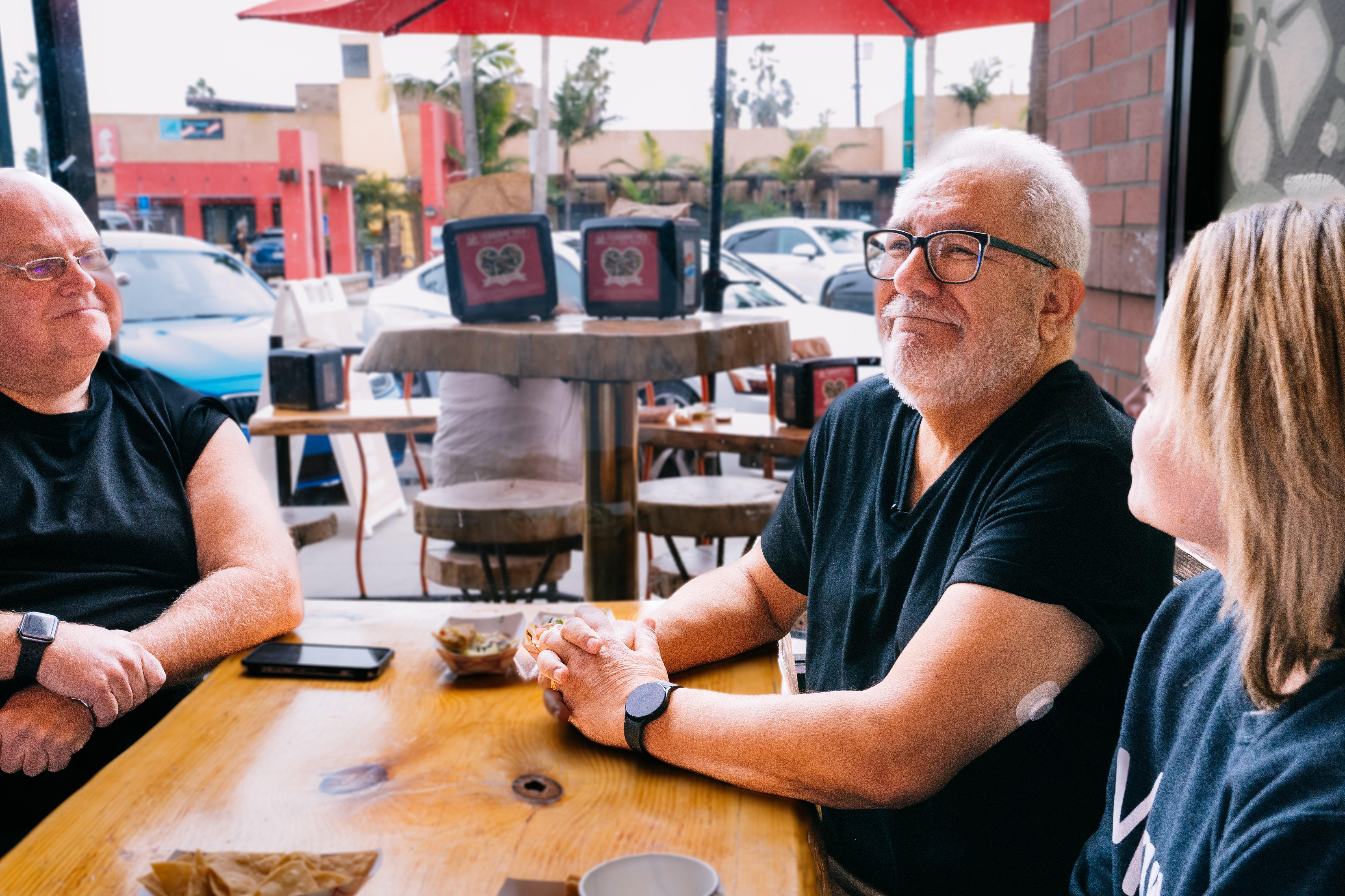 woman wearing dexcom g7 sensor on arm holding hands and walking with man