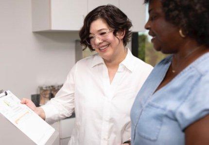 Two women looking at a clipboard