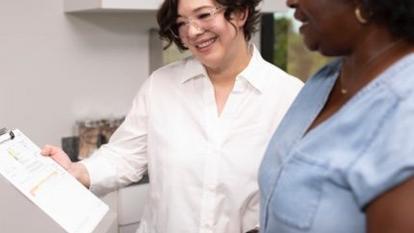 A woman looking at a clipboard