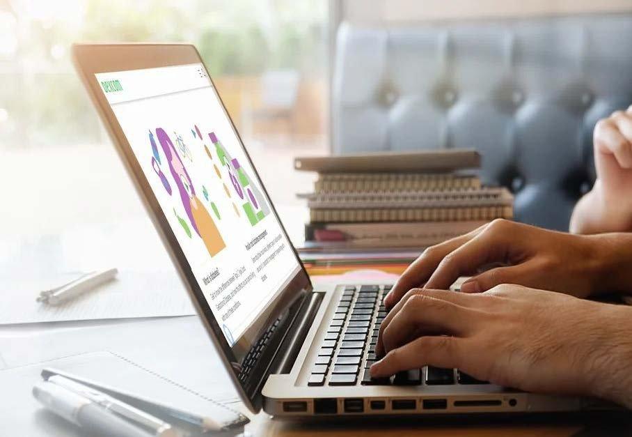 hands typing on laptop showing dexcom site