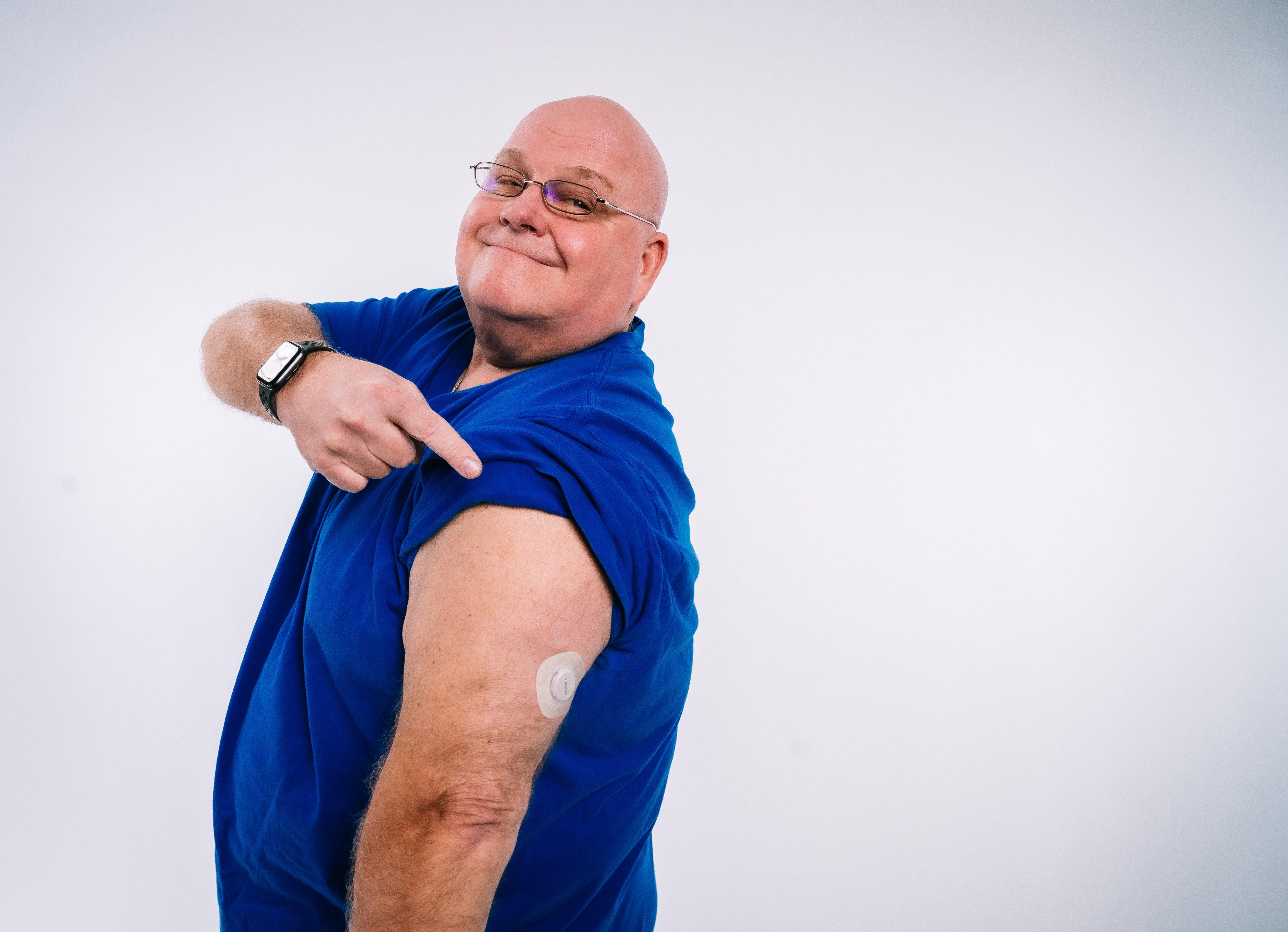 Dan T pointing to Dexcom G7 CGM sensor on his arm