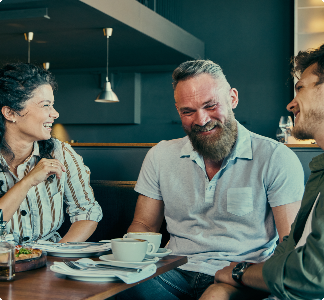women hugging at dinner table