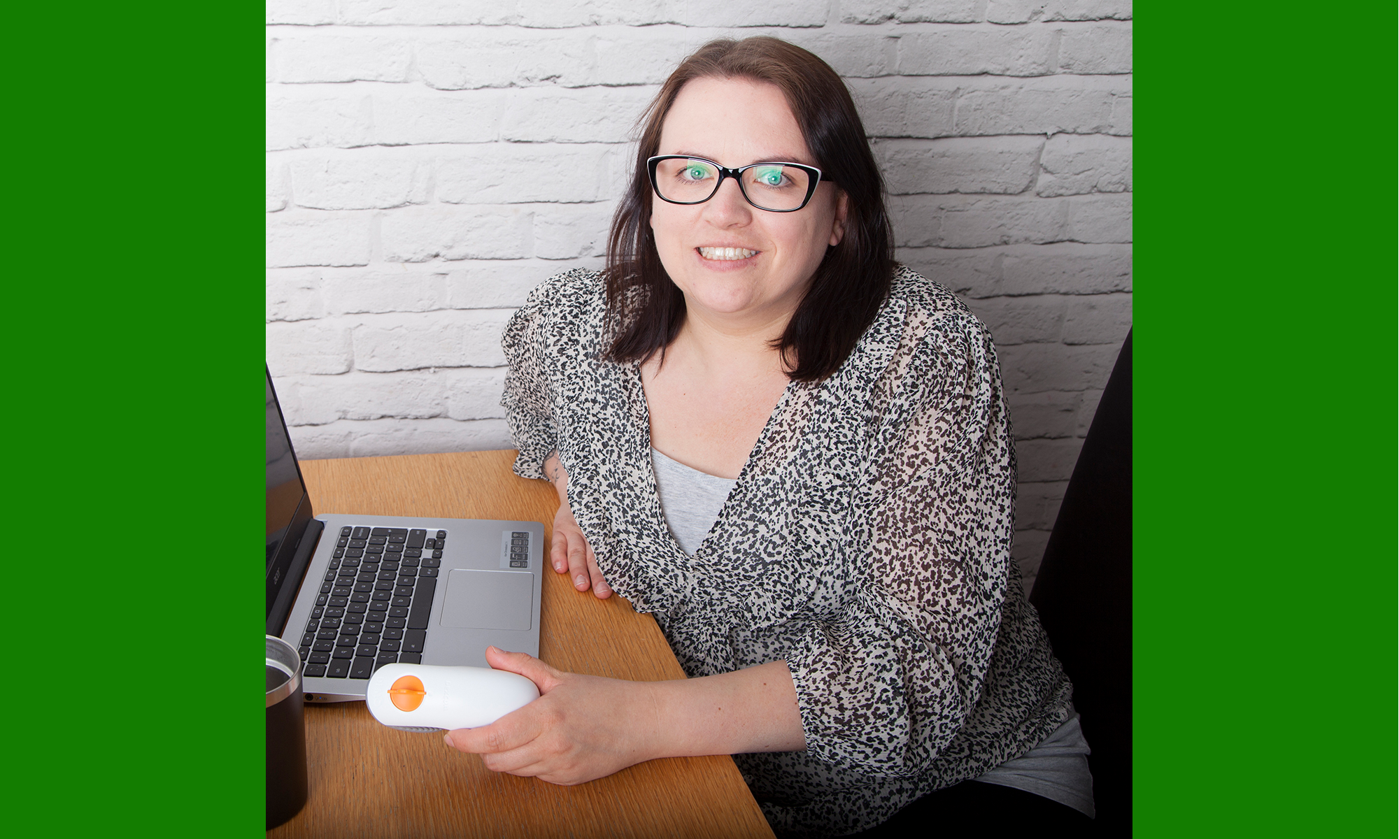 lady sitting at a laptop smiling
