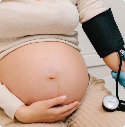 pregnant woman getting blood pressure monitored