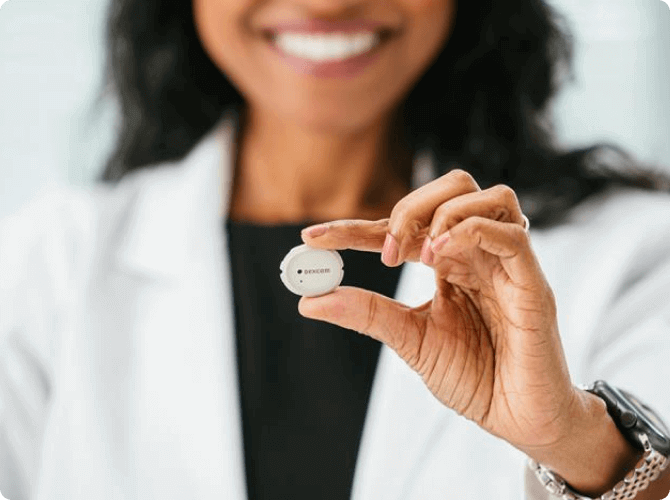 Doctor showing how small the Dexcom G7 15 Day sensor is