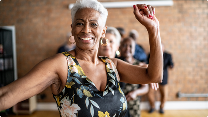 Older Woman Dancing with a group