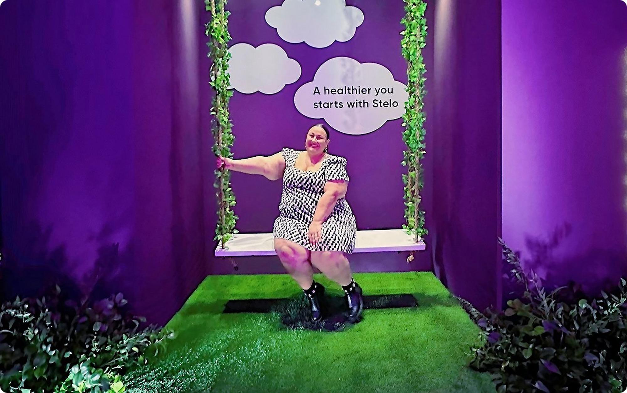 Stelo Ambassador Alysse on swing in purple room