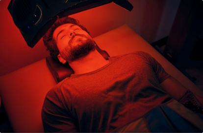 Man laying down with red light shining on him