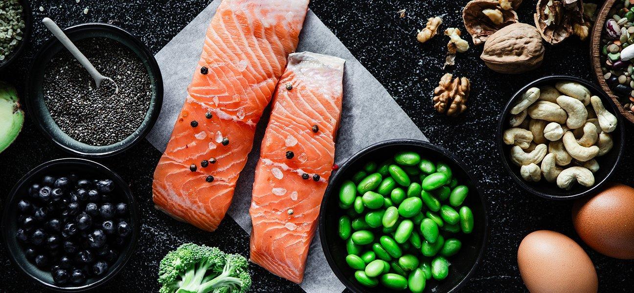 salmon next to healthy seeds, nuts and eggs