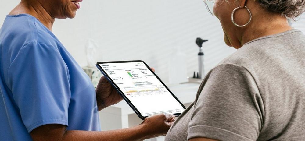 Doctor going over lab report with patient on a tablet