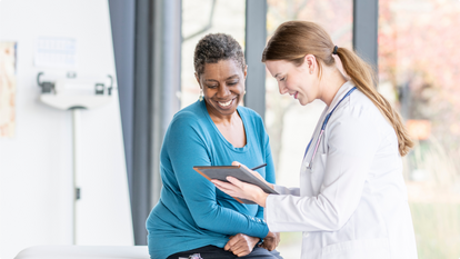 Doctor looking at charts with patient