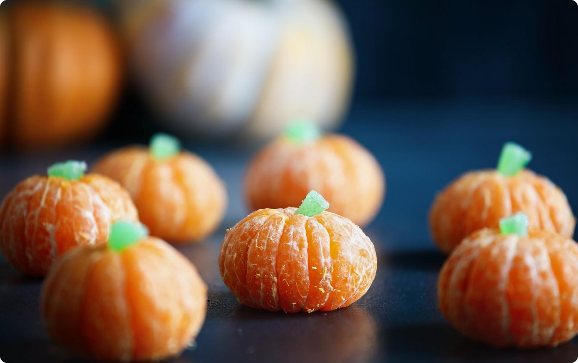 Oranges dressed up like pumpkins