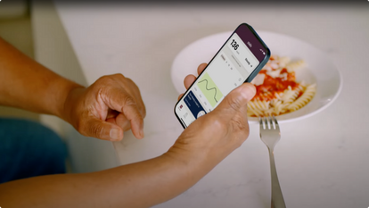 Person holding smart phone looking at Stelo app